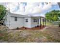 Charming house exterior with white siding and landscaping at 516 Poinsettia Rd, Auburndale, FL 33823