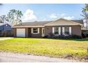 House exterior with a white garage door and front yard at 3933 Strickland Ct, Lakeland, FL 33812