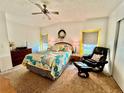 Bright bedroom with a queen-size bed and comfortable recliner at 1808 Quail Hill Dr, Lakeland, FL 33810