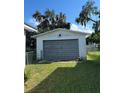 Detached garage with a large roll-up door at 2125 Monticello Ave, Lakeland, FL 33801