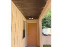 Orange front door and covered walkway leading to the house at 5009 Cimarron Dr, Lakeland, FL 33813