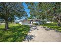 House with driveway and mature trees at 941 Devonshire Way, Lake Wales, FL 33853