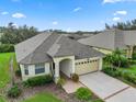 One story house with a two car garage, surrounded by other homes at 2356 Lake James Way, Lakeland, FL 33810