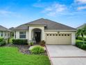 One story house with a two-car garage and manicured lawn at 2356 Lake James Way, Lakeland, FL 33810