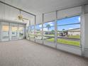 Bright screened porch with view of the community at 134 Lake Hazel Dr, Winter Haven, FL 33884