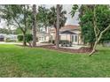 Spacious backyard with patio furniture and lush greenery at 1806 17Th Nw St, Winter Haven, FL 33881