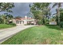 Charming house exterior with carport, landscaping, and detached shed at 1806 17Th Nw St, Winter Haven, FL 33881