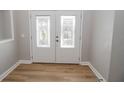 Bright entryway with double doors and wood flooring at 300 Winona Ct, Auburndale, FL 33823
