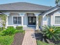 Front entryway with double doors and landscaping at 300 Winona Ct, Auburndale, FL 33823