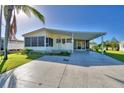 Yellow single-wide manufactured home with carport at 1742 Fox Hill Dr, Lakeland, FL 33810