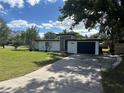 Mid-century modern home with white exterior, black accents, and a spacious lawn at 2128 Sycamore Dr, Winter Park, FL 32789