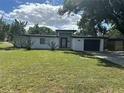 Mid-century modern home with white exterior, black accents, and a spacious lawn at 2128 Sycamore Dr, Winter Park, FL 32789