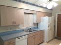 Galley kitchen with light wood cabinets and blue countertops at 1140 Durham Dr, Lakeland, FL 33809