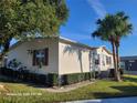 Mobile home with palm trees and a well-manicured lawn at 1744 Quail Hill Dr, Lakeland, FL 33810