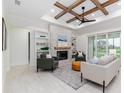 Living room with a fireplace, high ceilings, and sliding doors leading to the backyard at 1001 Cody Bluffs Rd, Babson Park, FL 33827