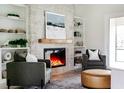 Cozy living room featuring a stone fireplace, built-in shelves, and comfortable seating at 1001 Cody Bluffs Rd, Babson Park, FL 33827
