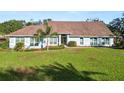 Single-story home with a spacious lawn and palm trees at 3445 Ewell Rd, Lakeland, FL 33811