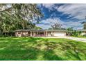 Brick ranch home with a two-car garage and lush lawn at 311 Wildwood Ave, Lakeland, FL 33809