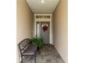 Inviting entryway with a bench and fall wreath at 7929 Lake James Blvd, Lakeland, FL 33810