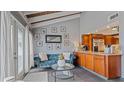 Bright living area with teal sofa and wood beam ceiling at 1 Loma Linda, Lakeland, FL 33813