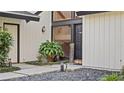 View of the front entrance with dark double doors and landscaping at 1215 Cypress E Pt, Winter Haven, FL 33884