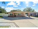 Brick home with a carport and paved driveway at 855 Candyce Ave, Lakeland, FL 33815