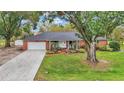 House with a large yard and driveway, offering ample space and curb appeal at 4264 Stafford Dr, Winter Haven, FL 33880