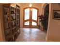 Bright entryway with tiled flooring and wooden shelving unit at 108 Lake Region N Blvd, Winter Haven, FL 33881