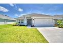 Single-story house with a two-car garage and grassy lawn at 1580 Leamington Ln, Winter Haven, FL 33884