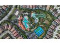 Community pool, lazy river, and tennis courts are visible from above at 7004 Oakwood St, Davenport, FL 33837