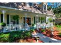 Two-story home's front porch features a white railing and green accents at 1159 Longwood Oaks Blvd, Lakeland, FL 33811