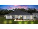 Newly constructed home with attached garage, manicured lawn and landscaping at 4510 Roundup Dr, Polk City, FL 33868