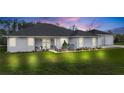 Attractive single-story home with attached garage at dusk at 4510 Roundup Dr, Polk City, FL 33868