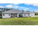 Single-story house with a two-car garage, well-maintained landscaping at 4510 Roundup Dr, Polk City, FL 33868