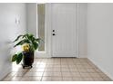 Bright entryway with tile flooring, a potted plant, and a white door at 6250 Sandpipers Dr, Lakeland, FL 33809