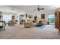 Spacious living room with beige carpeting, a seating area, and dining area at 6256 Sandpipers Dr, Lakeland, FL 33809