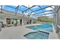 Inviting pool and spa with screened enclosure, creating a private oasis at 166 Golf Aire Blvd, Haines City, FL 33844