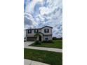 Two-story house with a neutral color scheme, landscaping, and a two-car garage at 2739 Red Egret Dr, Bartow, FL 33830
