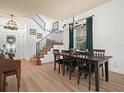 Formal dining room features a wood table, chandelier, and staircase at 4511 Micanope Crescent Dr, Lakeland, FL 33811
