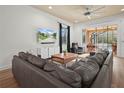 Spacious living room with sectional sofa, large TV, and access to the pool area at 4511 Micanope Crescent Dr, Lakeland, FL 33811