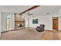 Living room featuring a brick fireplace and hardwood floors at 4616 Musket Dr, Lakeland, FL 33810