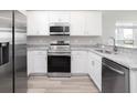 Modern kitchen featuring stainless steel appliances and granite countertops at 5108 Sylas Jax Ave, Winter Haven, FL 33884