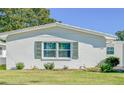 Single story home with green shutters and lawn at 718 Barber Cir # 718, Lakeland, FL 33803