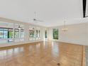 Spacious living room with tile floors and large windows at 14 Casa Loma Way, Lakeland, FL 33813