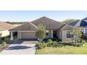Tan one-story house with a brown roof and large backyard at 1898 Charleston Ln, Bartow, FL 33830