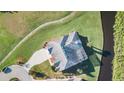 Single-story house with a large backyard near a waterway at 4402 Fairway Oaks Ct, Mulberry, FL 33860
