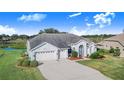 One-story house featuring a two-car garage and lush landscaping at 4402 Fairway Oaks Ct, Mulberry, FL 33860