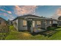 Home's backyard features a pergola-covered patio at 5873 Macaw Pl, Lakeland, FL 33809