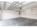 Garage with overhead storage, door to house, and an epoxy floor at 7018 Cascades Ct, Lakeland, FL 33813