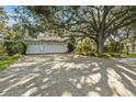 Three-car garage with large driveway, providing ample parking at 150 Woodcrest Ln, Mulberry, FL 33860